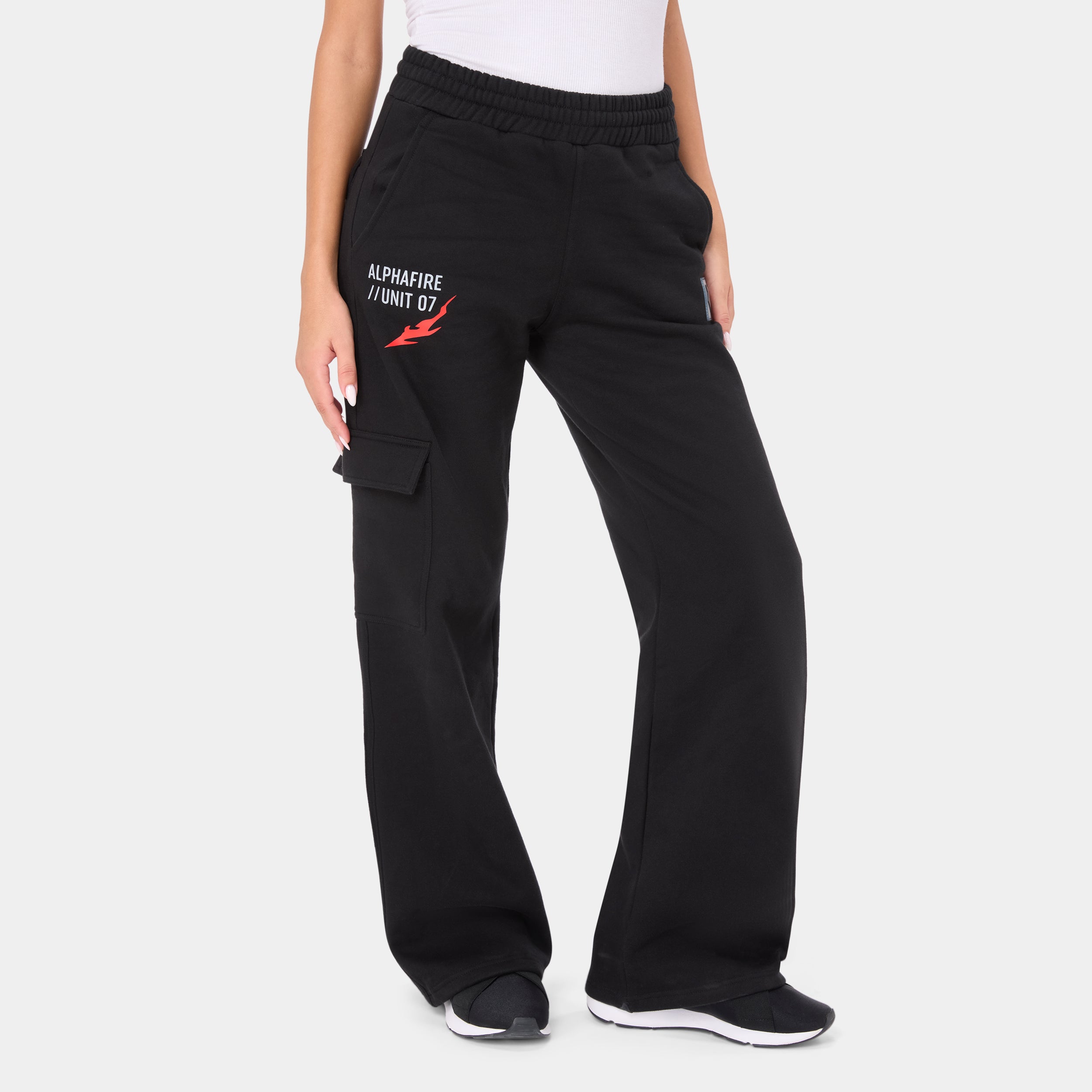 ALPHAFIRE BOTTOM — WAR BLACK — Front ¾ view waist-down, black cargo pants with ALPHAFIRE UNIT 07 red flame graphic