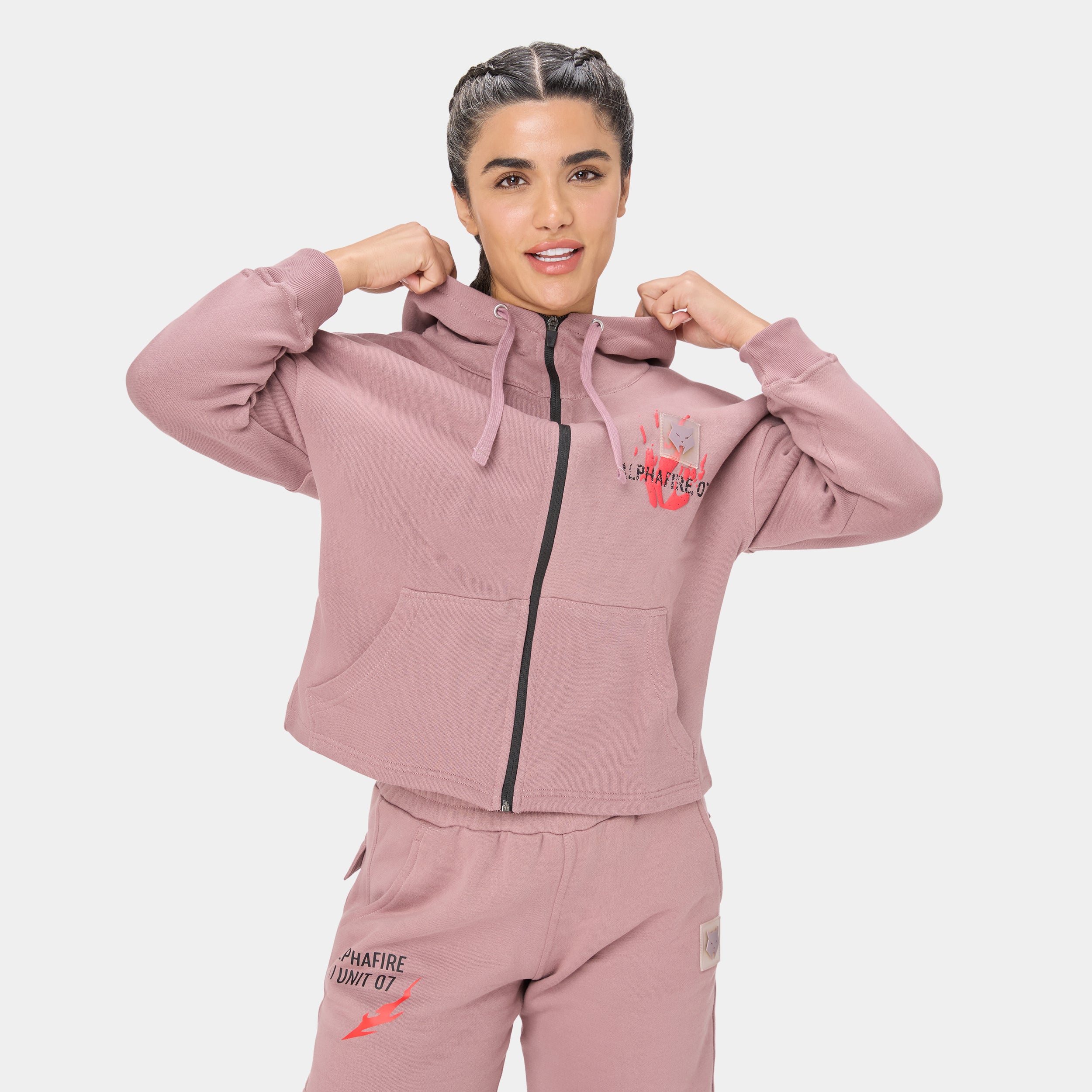ALPHAFIRE CROP HOODIE — STORM ROSE — Front close-up torso alternate pose, dusty pink hoodie with model flexing arms, Alpha...
