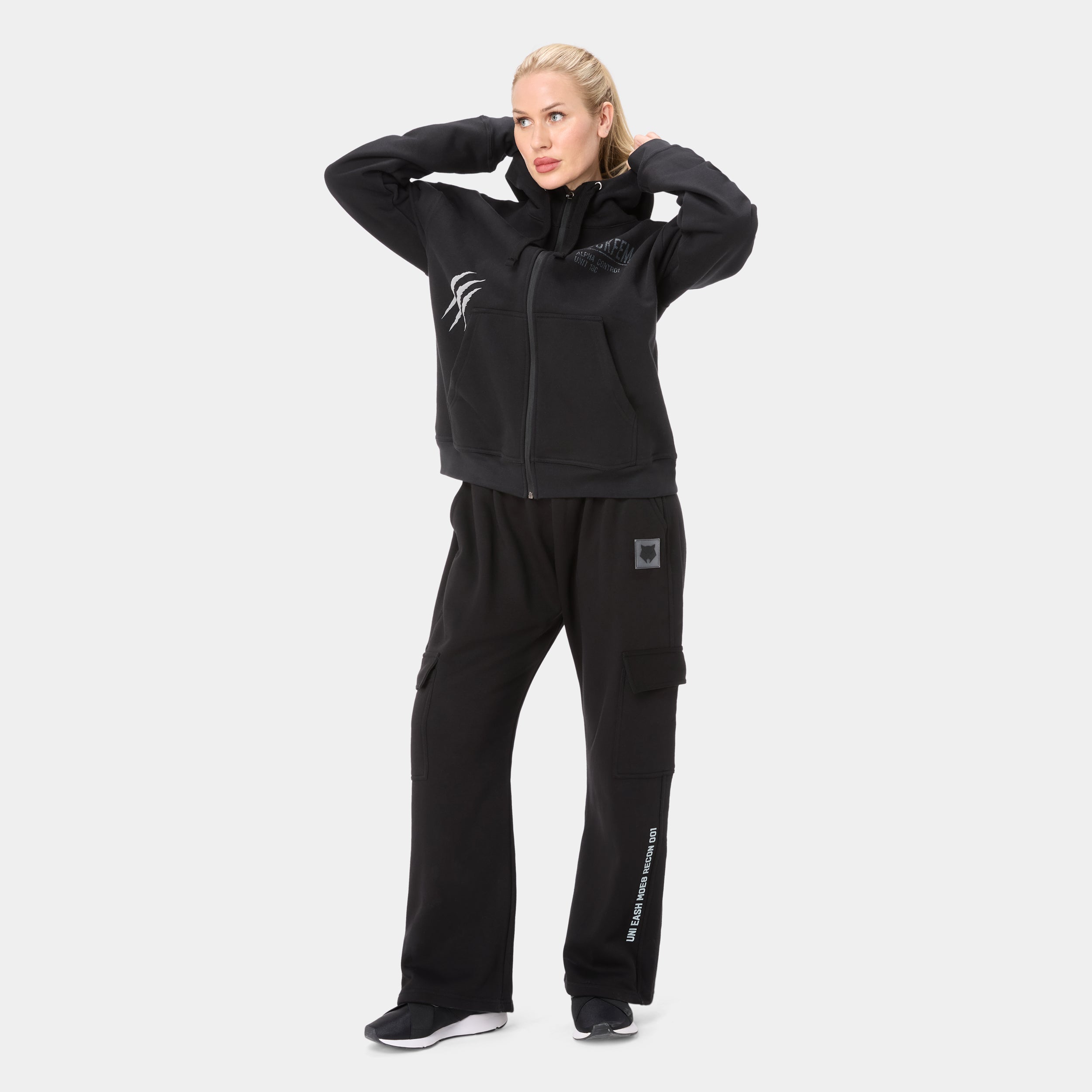 LOCKFEM_05 HOODIE — WAR BLACK — Full-body front view, black zip-up hoodie paired with black cargo pants showing Unleash Mode