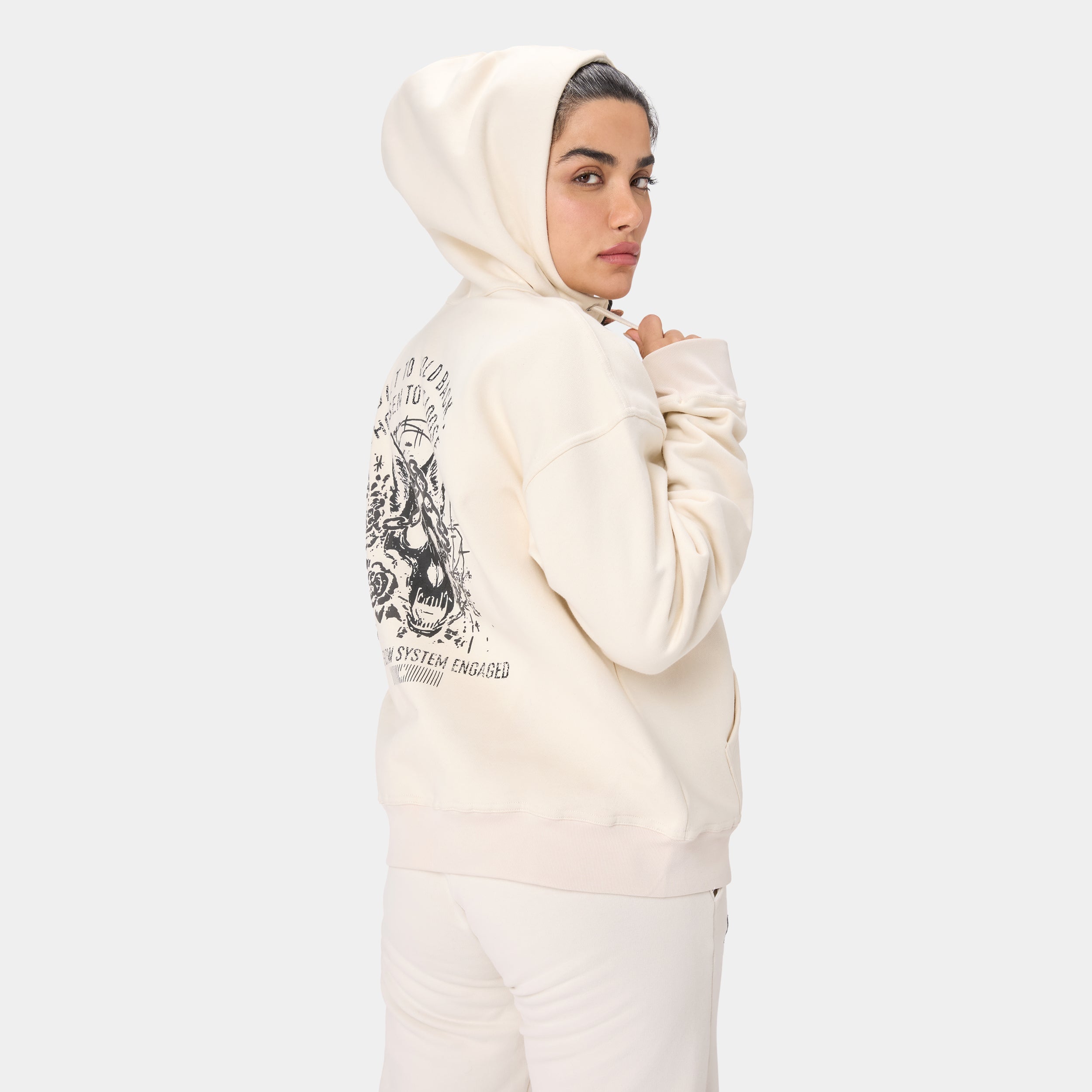 LOCKFEM_05 HOODIE — TACTICAL BEIGE — Back/side view upper body, cream hoodie with wolf skull/butterfly back graphic, hood up