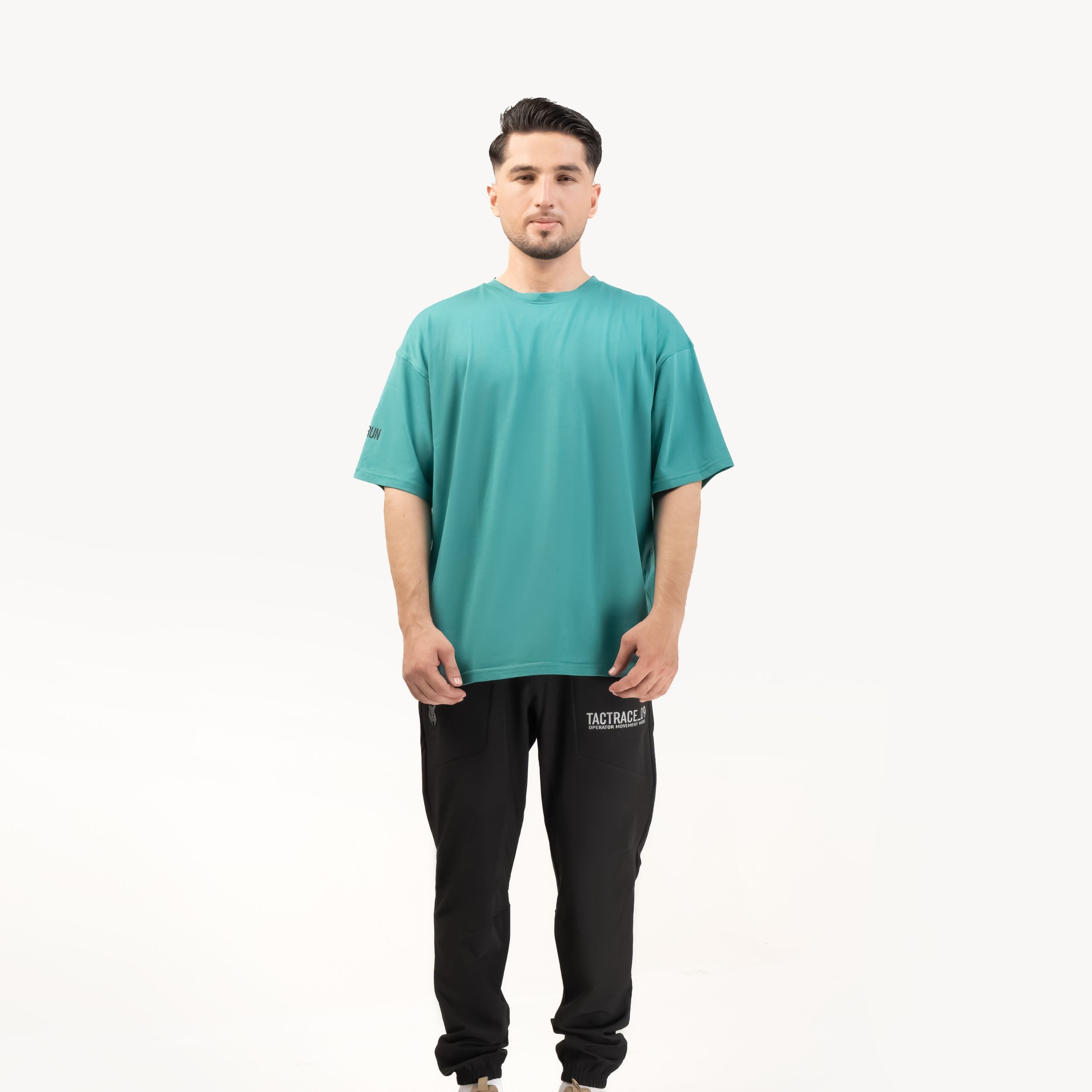 OPERATOR_77 OVERSIZED TEE — ROUGE GREEN — Full-body straight-on view on male model, white background, teal tee complete outf